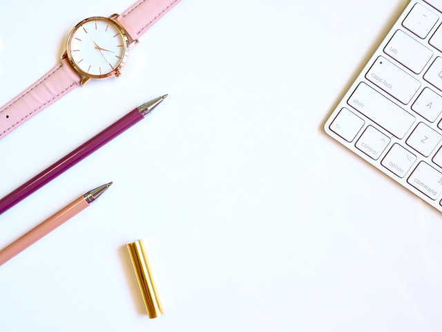 tools for planning moving cross country in 2021- a watch, pens, and a planning document from a move manager